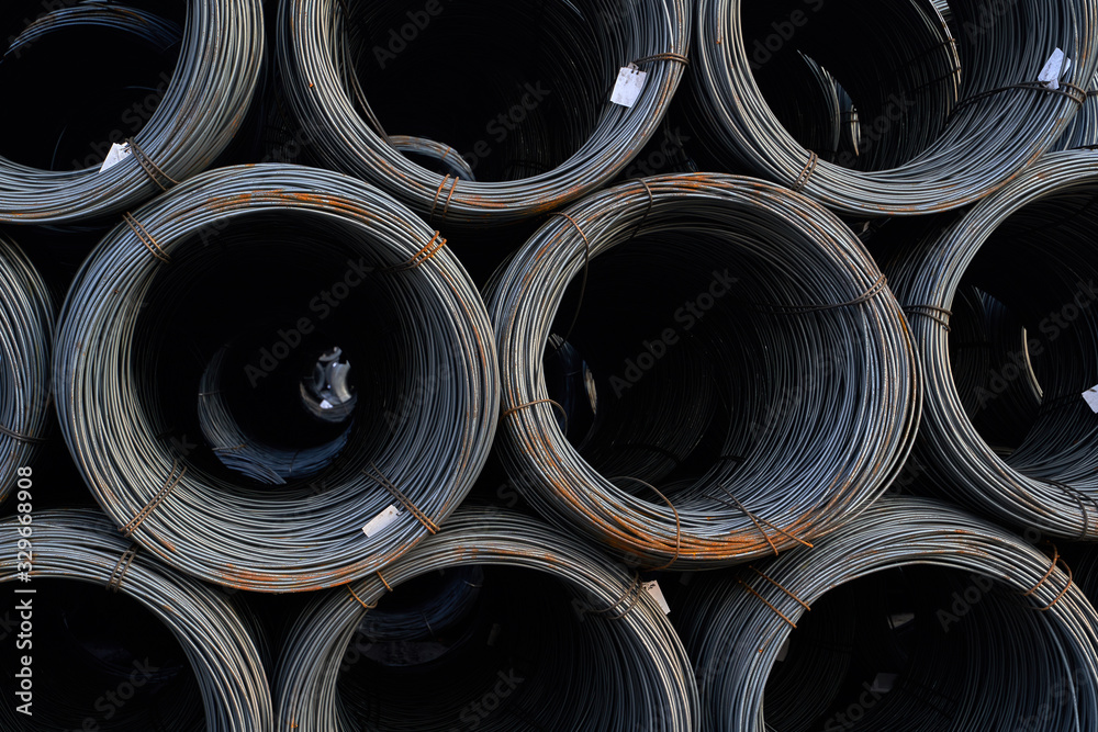 Sea transportation of cargo. Bays of steel wire at sea berth prepared for loading on cargo ship. Thin metal reinforcement wound into bays at the metal products warehouse Sea transportation of cargo. Bays of steel wire at sea berth prepared for loading on cargo ship. Thin metal reinforcement wound into bays at the metal products warehouse
