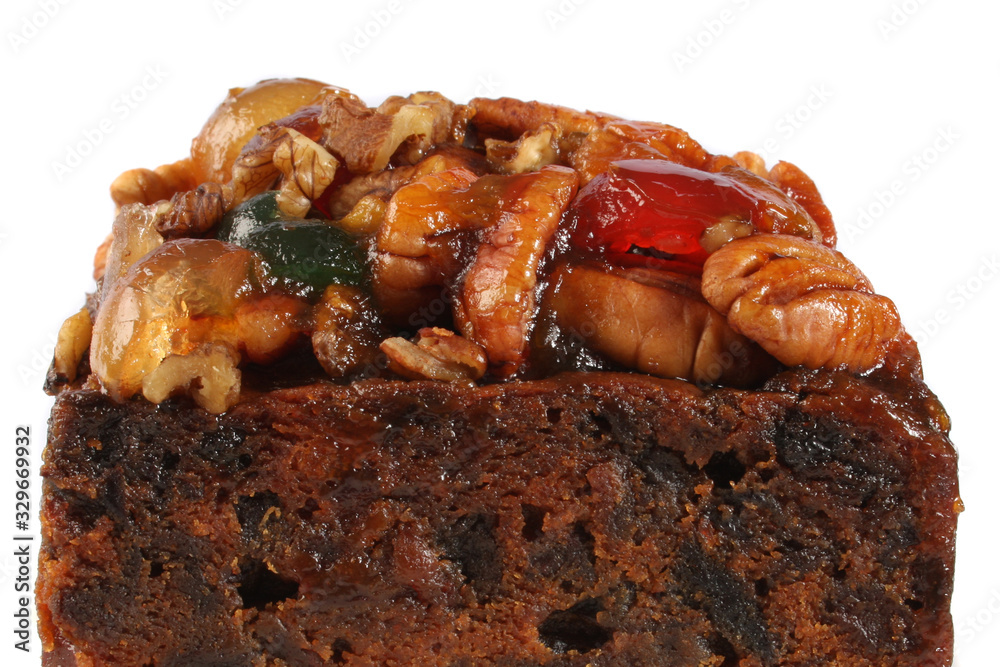 A rich fruitcake photographed against a white background A rich fruitcake photographed against a white background