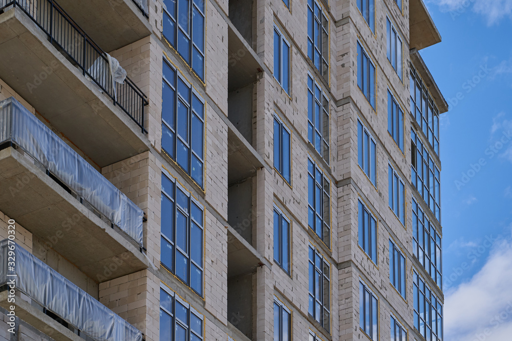 Obraz premium Construction site. High rise Building under construction. Construction of high-rise residential building