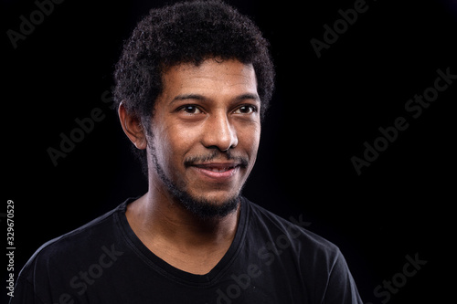 Studio portrait of handsome african guy with beard and moustache. Low key portrait, black background...