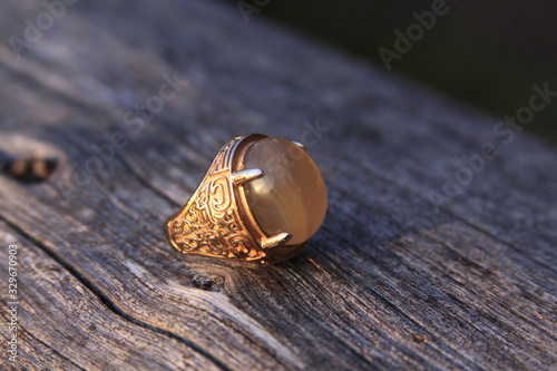 Muslim men aqeeq mood ring with agate gemstone on wood