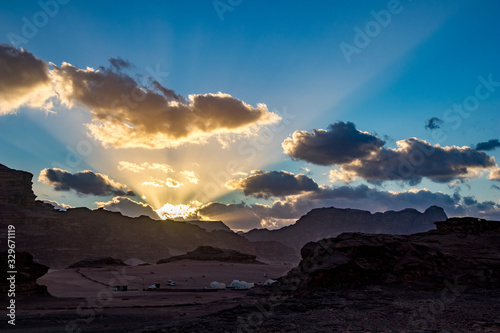 Kingdom of Jordan  Wadi Rum desert  impressive sunset sky and light over desert in darkness and shadows. Lovely travel photography. Beautiful desert could be explored on safari. Colorful image