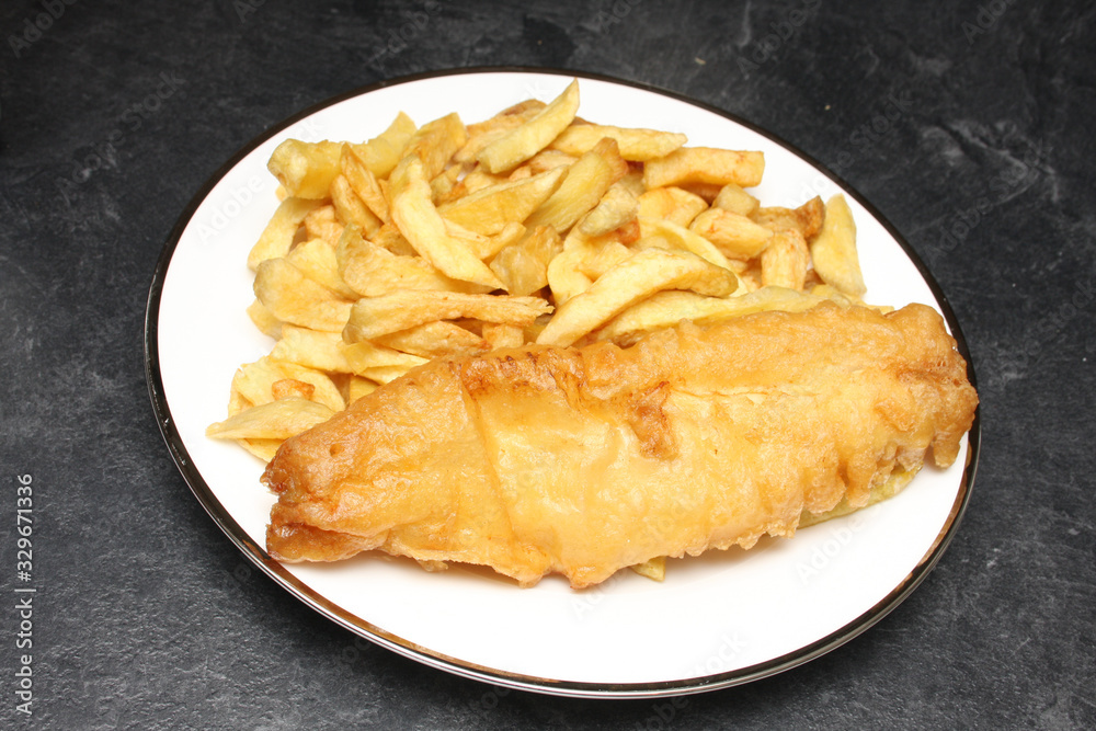 A plate of fish and chips from an English fish and chips shop A plate of fish and chips from an English fish and chips shop