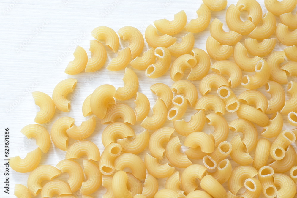 Italian short pasta, on white wooden background Italian short pasta, on white wooden background