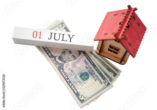 Money, home and calendar. The concept of financial independence and the scheduled start date for July 1