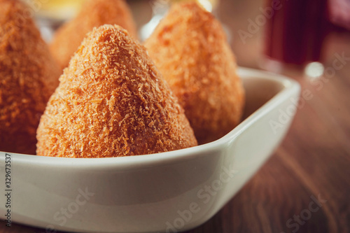 Photography Coxinha de frango (Brazilian appetiser stuffed with chicken) in close up with a