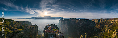 Aerial view of monastery Trinity and breathtaking pictures of valley and landmark canyon of Meteora at sunset, Kalambaka, Greece, shadows, twisted road, bridge, Mountains as columns photo