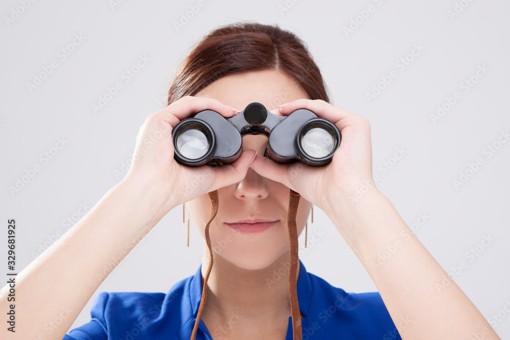 Information Search Concepts. Caucasian Brunette Female Posing With Binoculars as a Concept of Search. Information Search Concepts. Caucasian Brunette Female Posing With Binoculars as a Concept of Search.