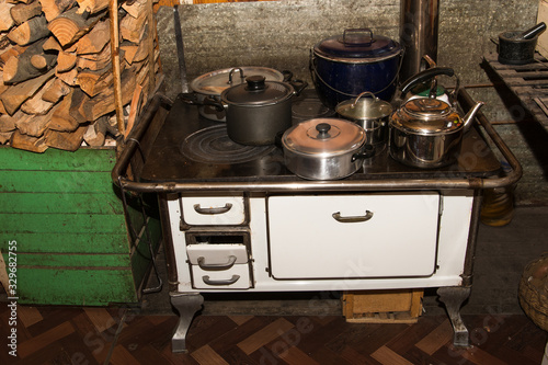 White wood stove with many holes on top, perfect for heating the house and making food, widely used in chile