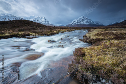 the river coupall waterfalls on rannoch moor showing buachaille etive mor in the background as the entrance to glencoe valley in winter