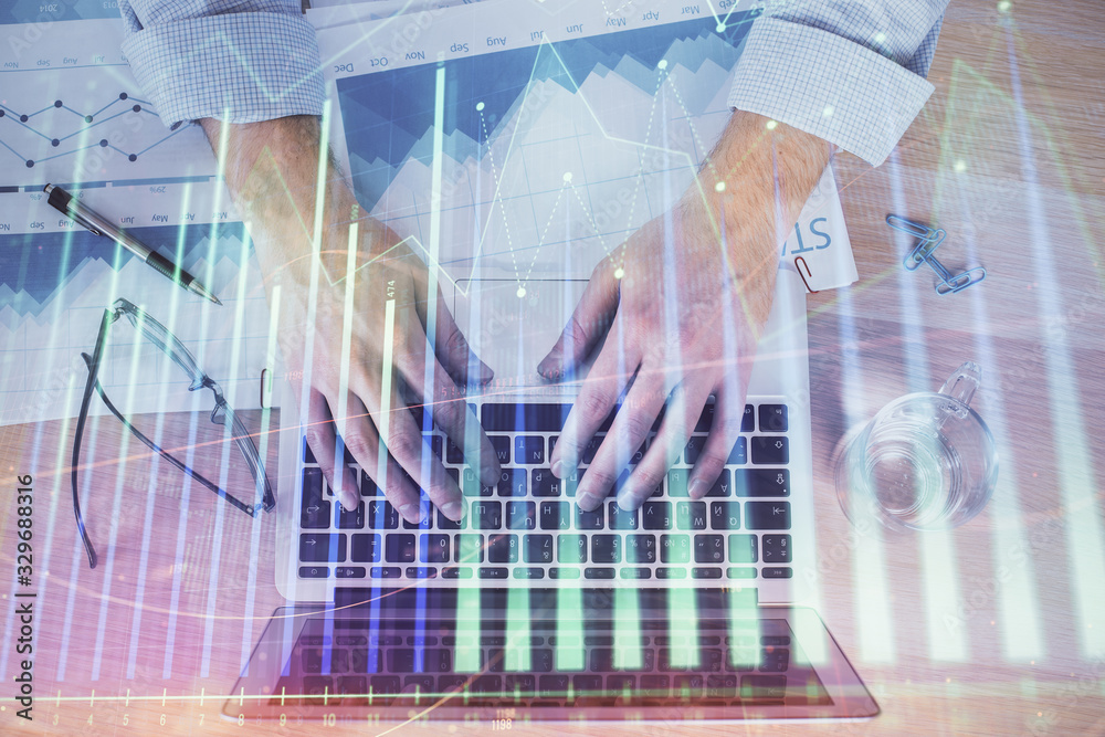 Double exposure of market chart with man working on computer on background. Concept of financial analysis. Double exposure of market chart with man working on computer on background. Concept of financial analysis.