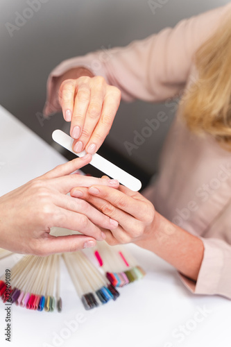 Close up of manicure master that correcting nail