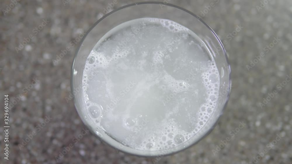 A vitamin C tablet dissolves in a pure water glass A vitamin C tablet dissolves in a pure water glass