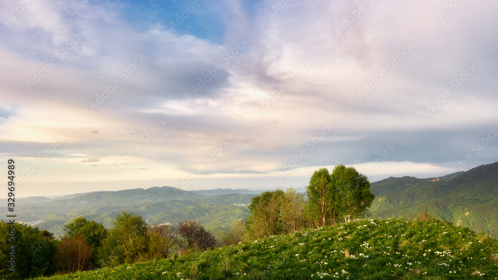 Mountain field during sunset with mountains in the background. Adygea, do-do-gush. Beautiful natural landscape. High quality photo Mountain field during sunset with mountains in the background. Adygea, do-do-gush. Beautiful natural landscape. High quality photo