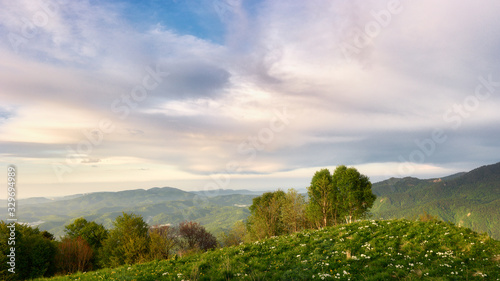 Mountain field during sunset with mountains in the background. Adygea, do-do-gush. Beautiful natural landscape. High quality photo