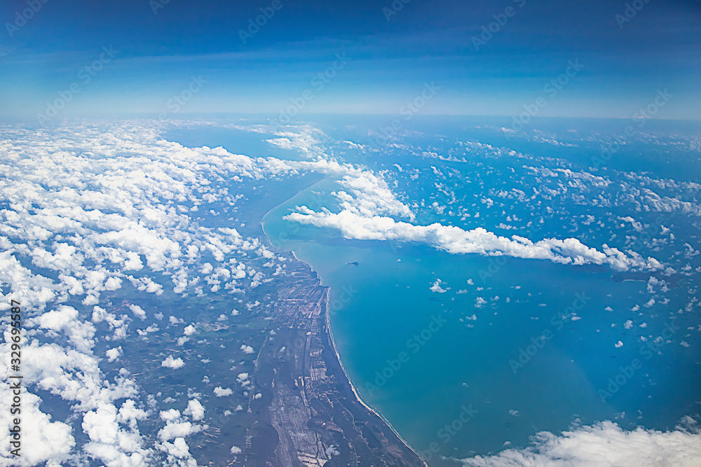 View from above on the earth, clouds and the sea. Aerial view of the coast of Malaysia