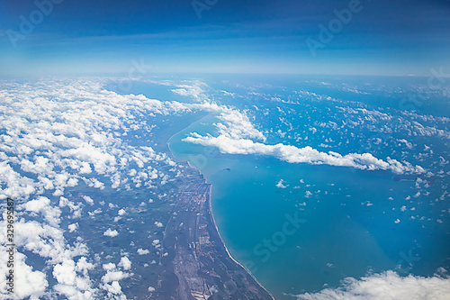 View from above on the earth, clouds and the sea. Aerial view of the coast of Malaysia