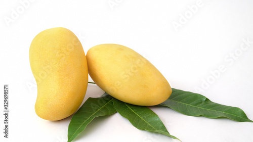 Close up view of mangoes and leavesl isolated on white background