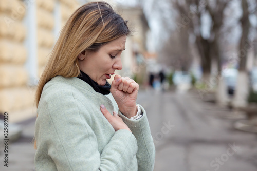 young woman coughing feeling bad