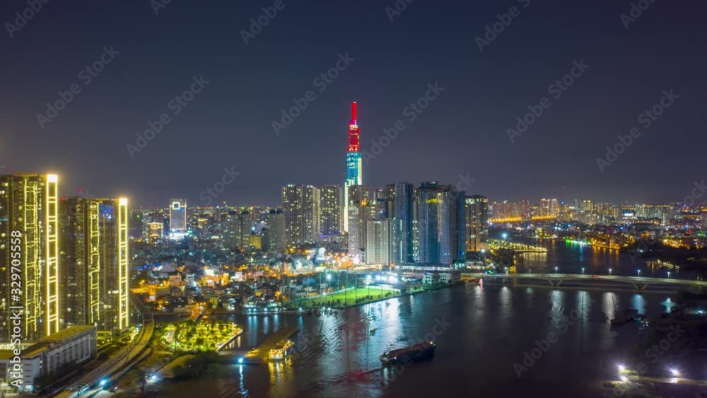 Aerial hyper lapse Vinhomes Landmark 81 at night with Vietnam Flag on top Aerial hyper lapse Vinhomes Landmark 81 at night with Vietnam Flag on top