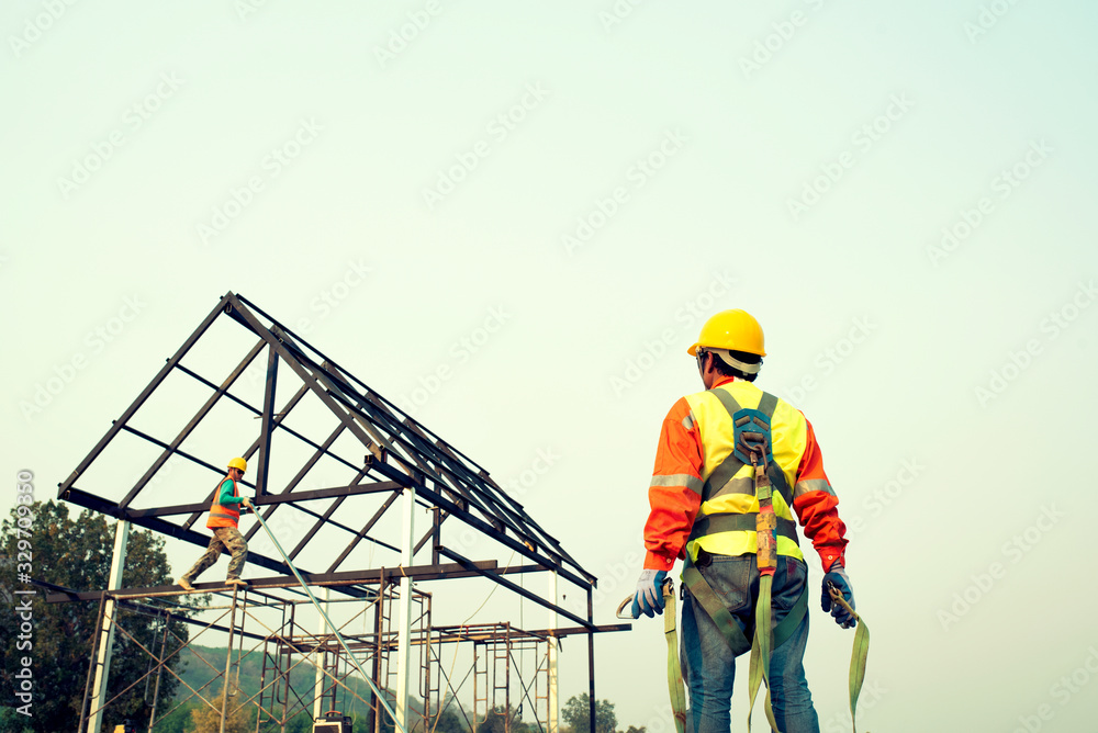 Construction team engineers wear steel roof safety inspection uniforms for roofing industry concepts. Construction team engineers wear steel roof safety inspection uniforms for roofing industry concepts.