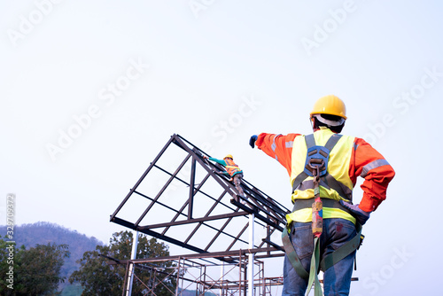 Construction team engineers wear steel roof safety inspection uniforms for roofing industry concepts.