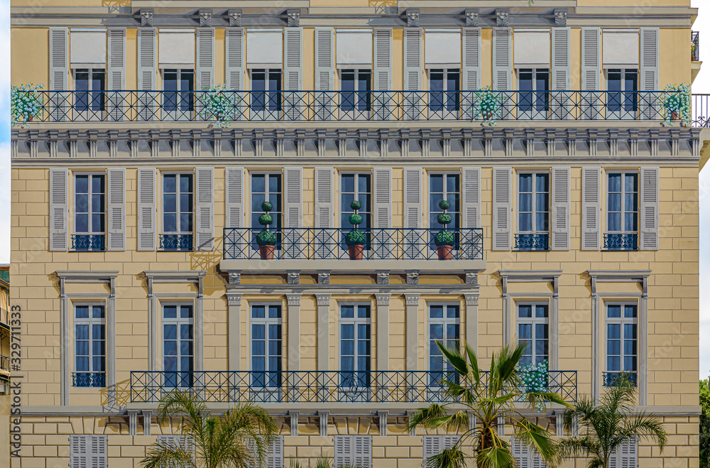 Traditional Mediterranean facade of a bourgeois building with illusion paint work in Nice, South of France