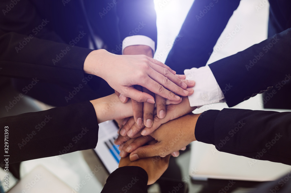 Close up on hands of business people join together their hands together on unity concept Close up on hands of business people join together their hands together on unity concept