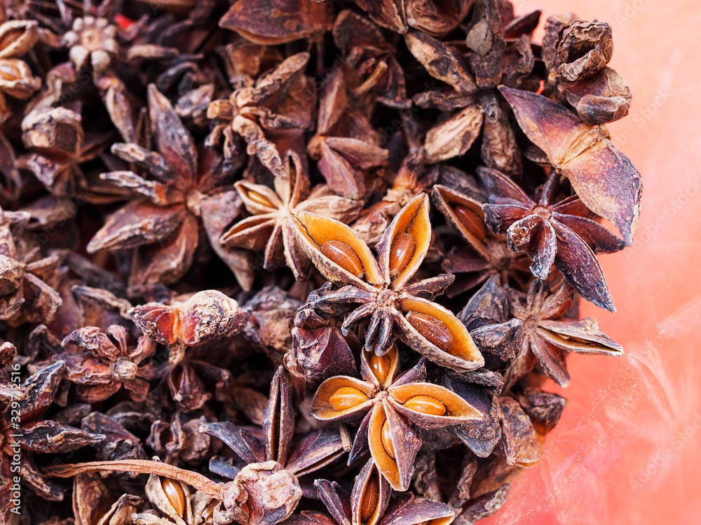 Aroma of dried herbs and spices with whole aromatic brown badian star anise or Illicium verum.