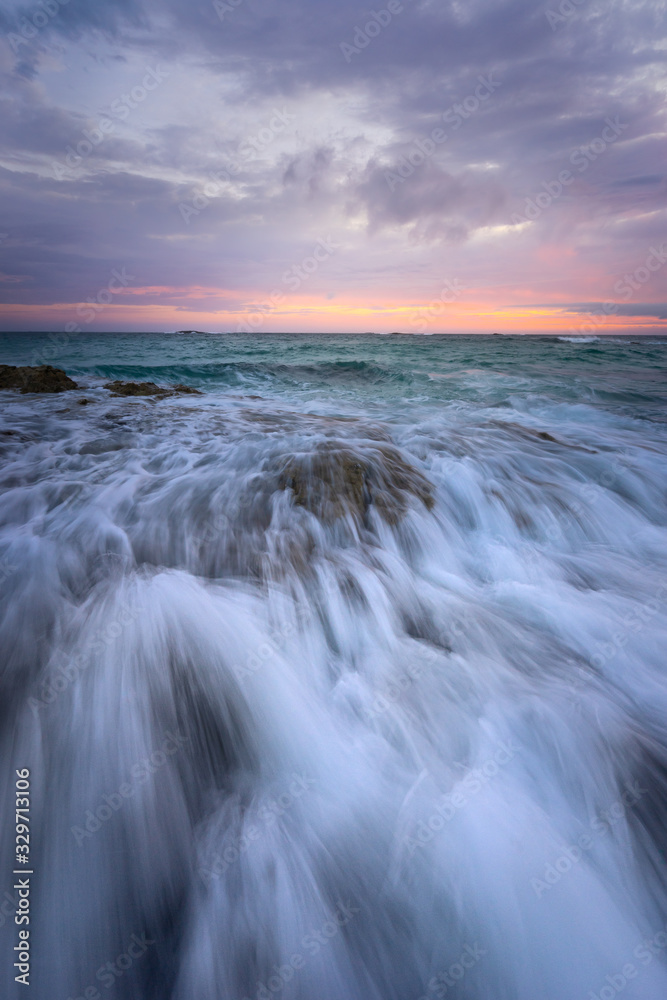 waves on beach at sunset