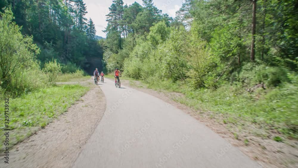 Active family of four cycling in nature Slovenia, tracking real-time Active family of four cycling in nature Slovenia, tracking real-time