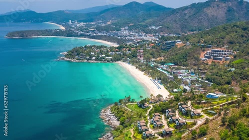 Aerial hyperlapse of the coast of Phuket island in Thailand. Flight over the beaches of Kata Noi, Kata and Karon during the sunny day with clouds in the sky. Timelapse of the tropical island of Phuket