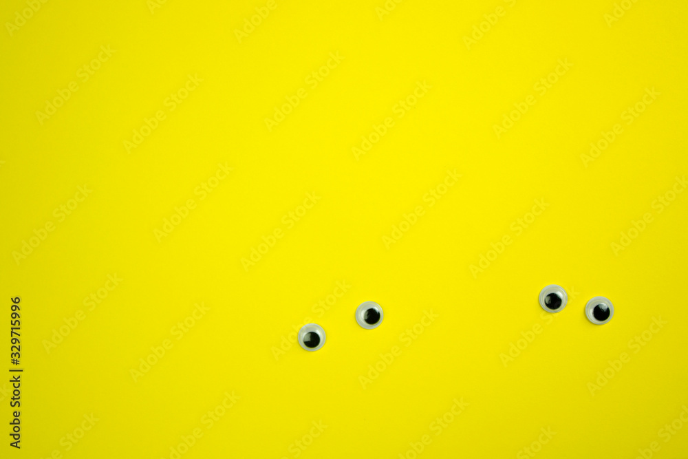 Fototapeta premium plastic pair of eyes on a bright background, place for text, minimalism concept