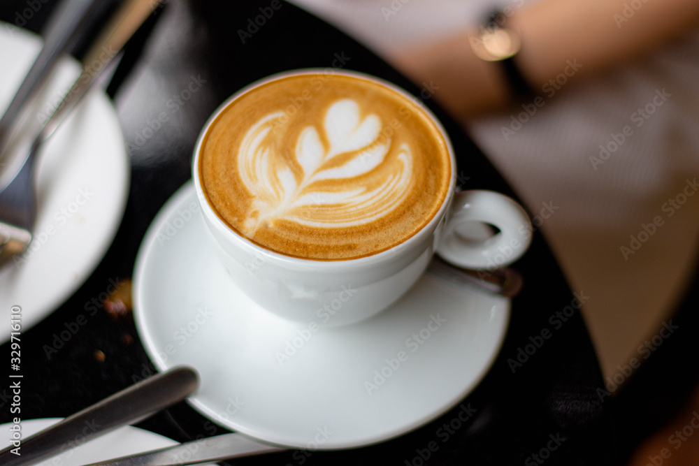 View side of hot coffee latte with latte art View side of hot coffee latte with latte art