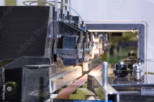 Feeding rollers of the automatic machine. Woodworking machine. Automated line. Defocused background.