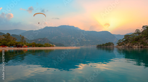 Paraglider flies in the sky at sunset - Oludeniz, Fethiye © muratart