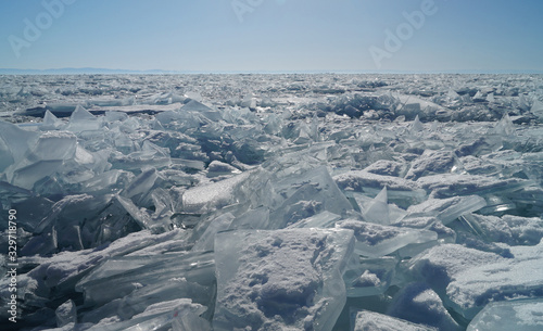 Transparent, shiny ice hummocks are visible to the horizon