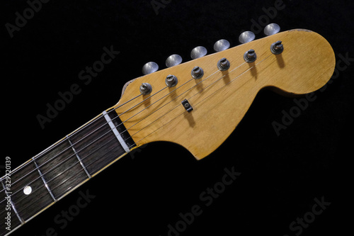 close up detail of electric guitar headstock, with selective focus.