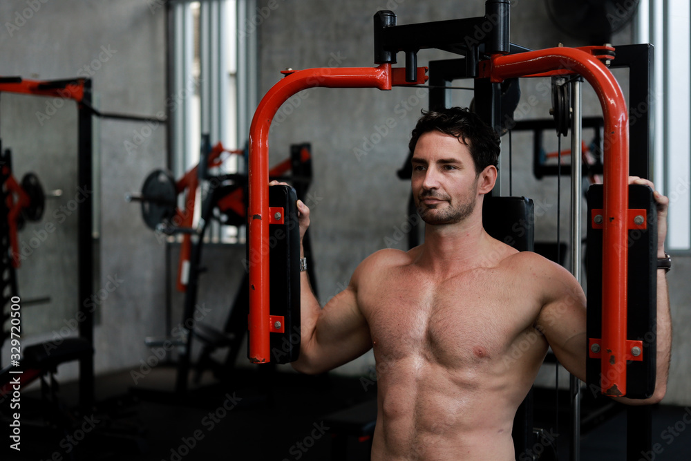Handsome Man exercise in gym body-building with muscular strong body Handsome Man exercise in gym body-building with muscular strong body