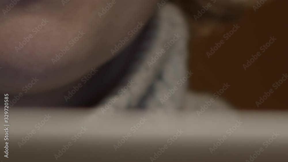 Woman holds finger to lips in deep concentration, extreme close-up