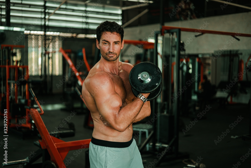 Handsome Man exercise in gym body-building with muscular strong body Handsome Man exercise in gym body-building with muscular strong body