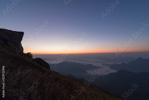 The scenery of Phu Chi Fah with twilight sky and sea of fog before sunrise in Chiang Rai, Thailand.