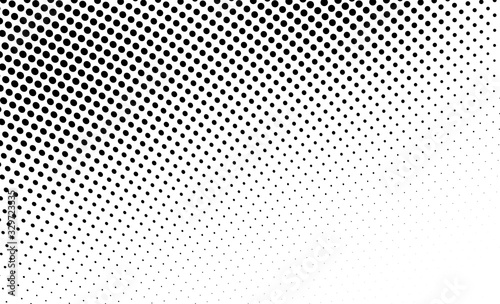 Abstract monochrome halftone texture. Chaotic wave of black dots on a white background