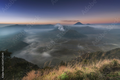 Beautiful view of Bromo, Batok and Semeru volcano with sea of fog at dawn in Java, Indonesia.