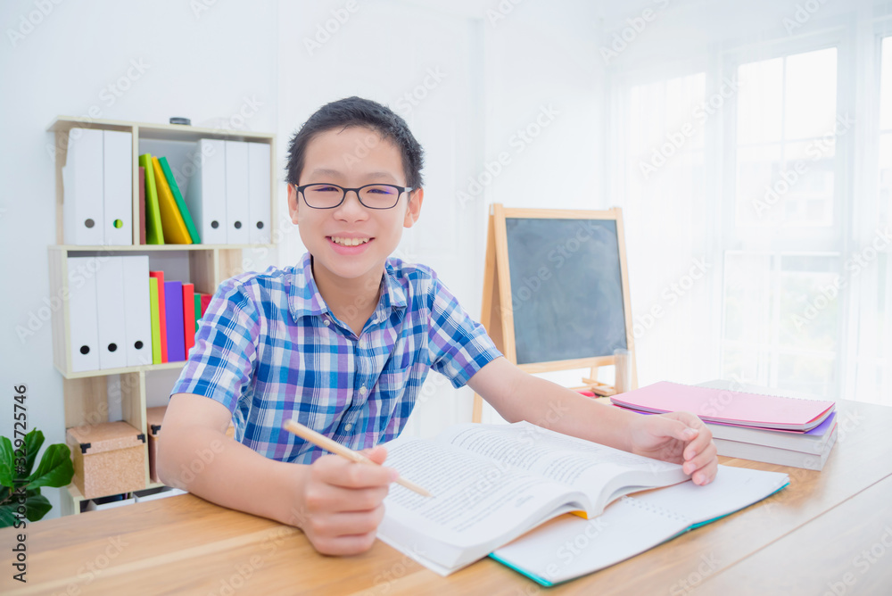 Young asian boy reading book,preparing for examination . Education concept. Young asian boy reading book,preparing for examination . Education concept.