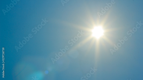 Shining sun at clear blue sky with copy space