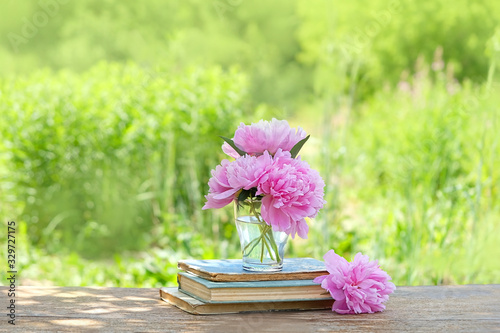 pink peony Flowers and books in summer garden. beautiful summer season scene. copy space