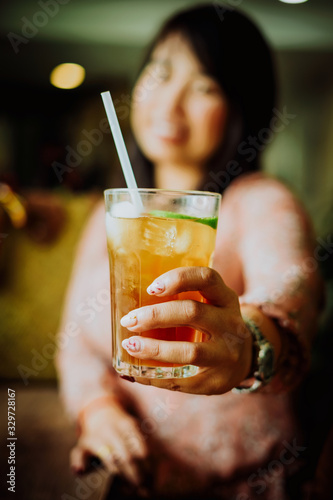 Woman holding a glass of ice tea