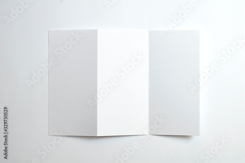Blank opened tri fold brochure isolated on white as template for design presentation, showcase, etc.