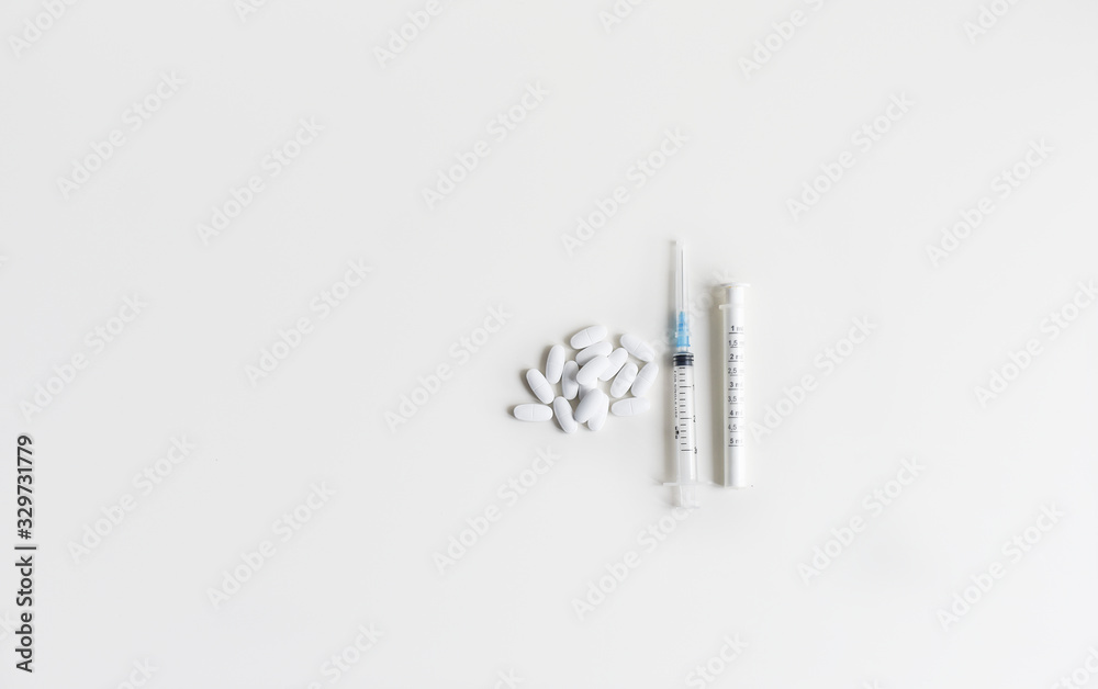syringe and pills still life on a medical topic